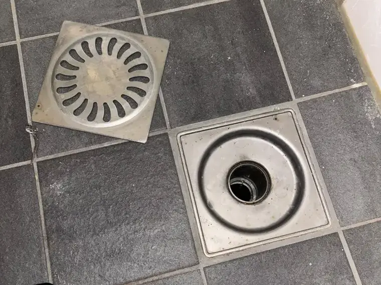 Vloerput en afvoerputje in een tegelvloer